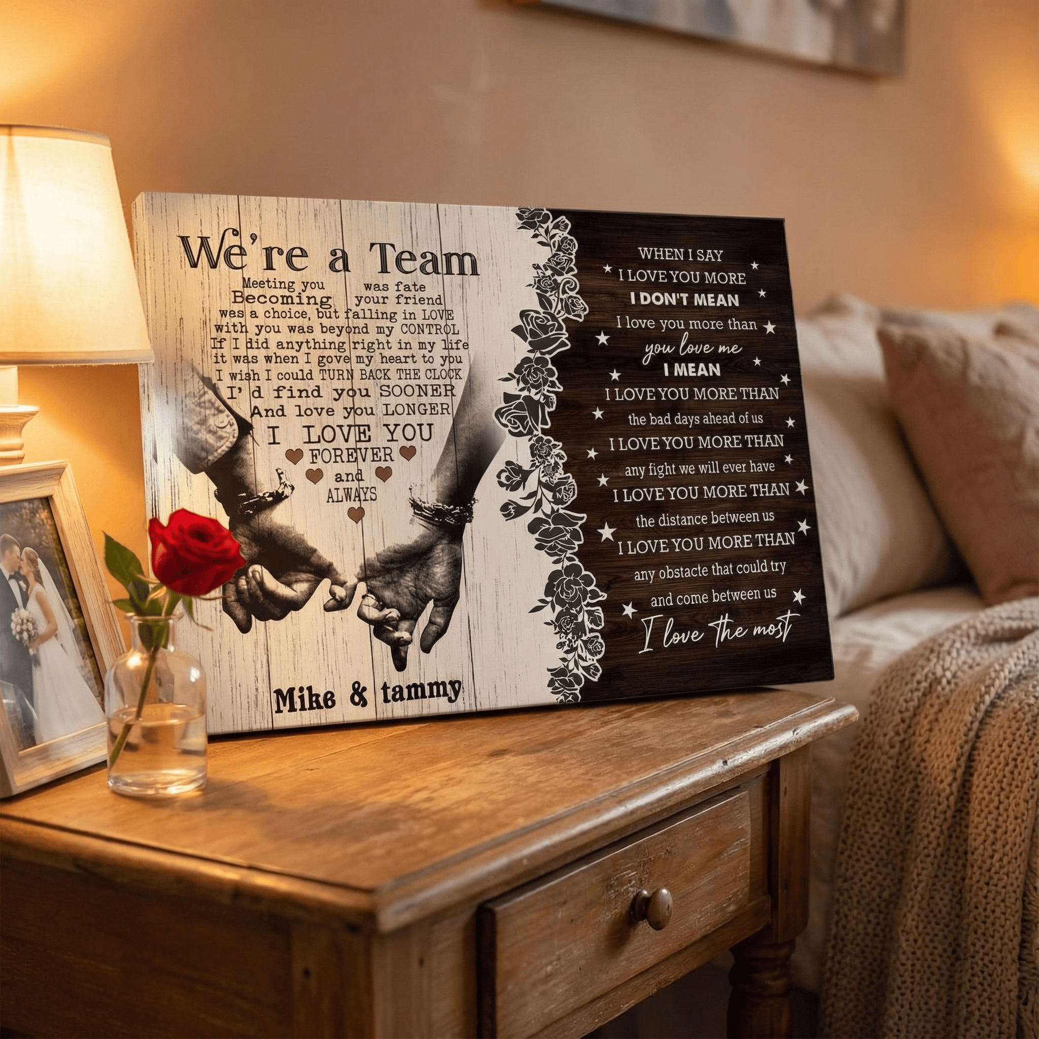 Decorative wall art with intertwined hands and romantic text on a wooden surface.