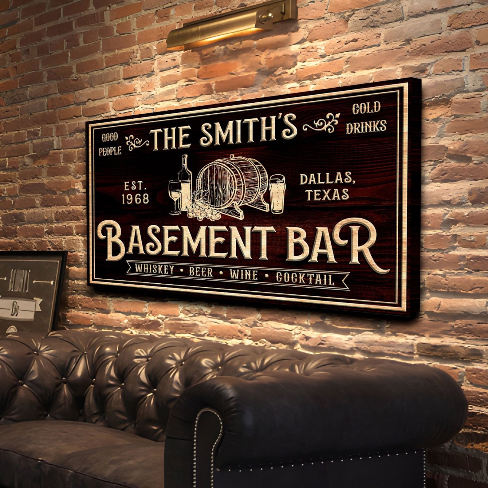 Personalized basement bar sign on a brick wall with a leather couch.
