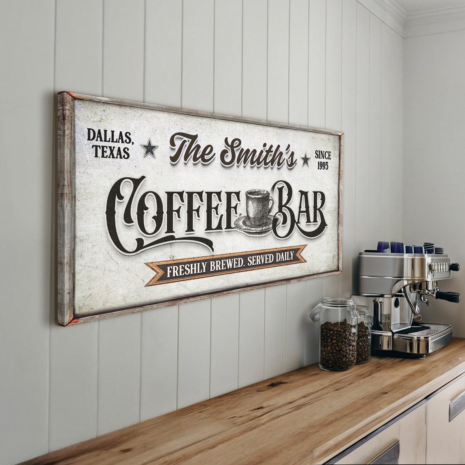 Personalized coffee bar sign on a wall above a wooden counter with coffee equipment.